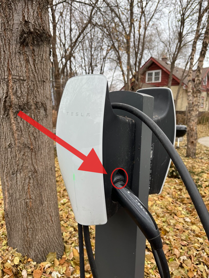 photo of charger with button circled in red, with arrow pointing to it