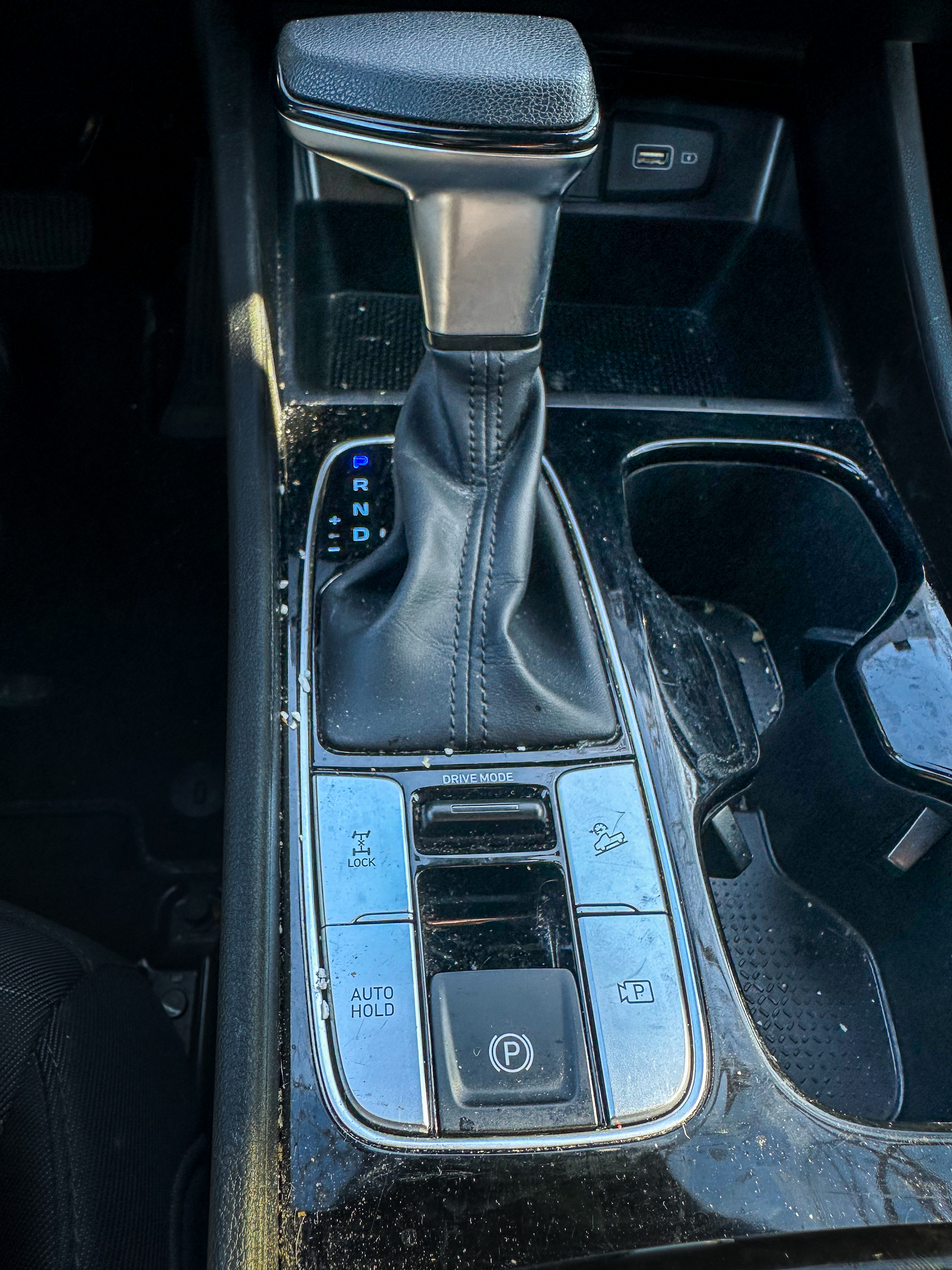 A photo of the Hyundai Santa Cruz parking brake switch, located in the center console