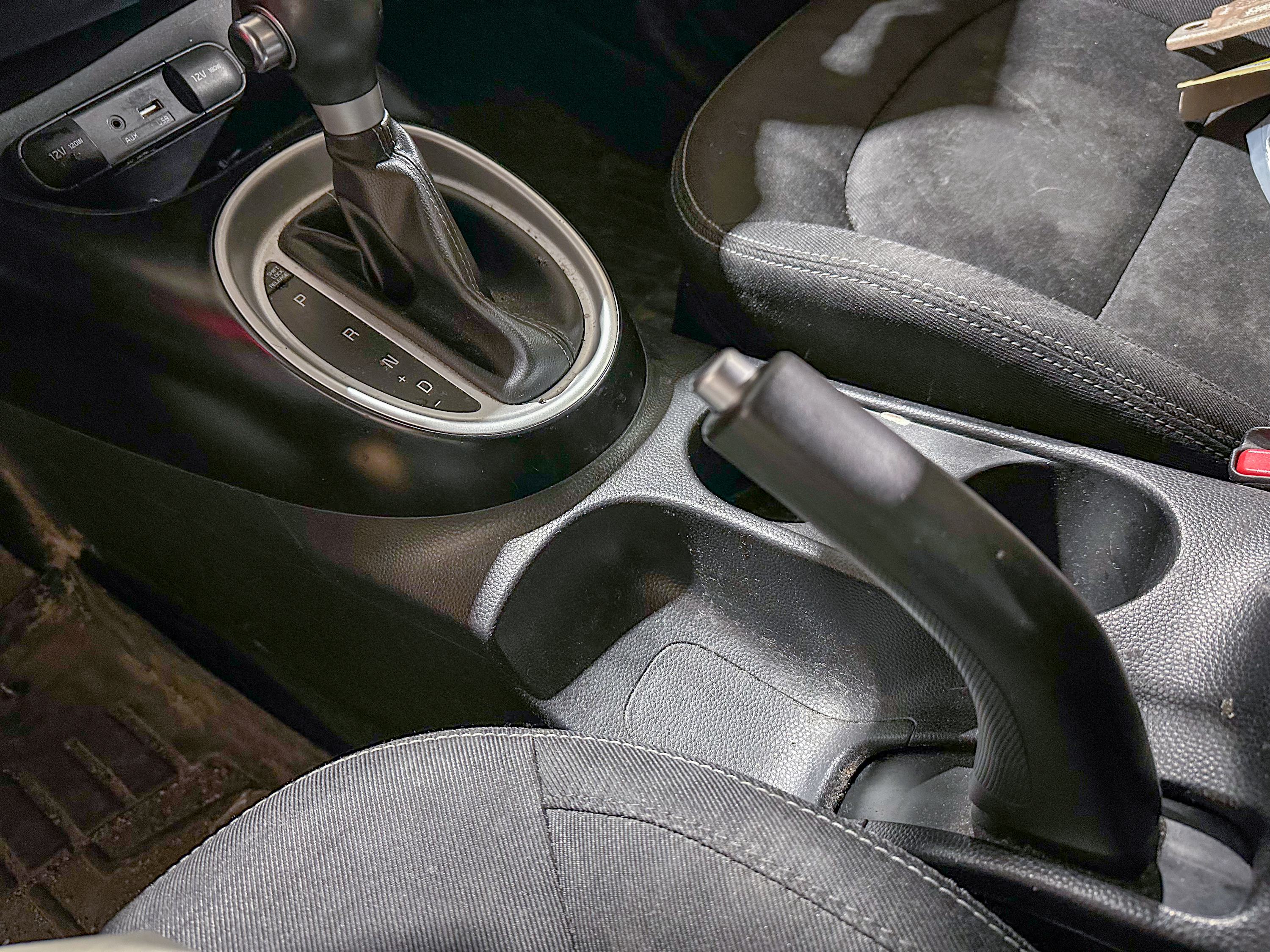 A photo of the Kia Soul parking brake lever in its on position, located in the center console